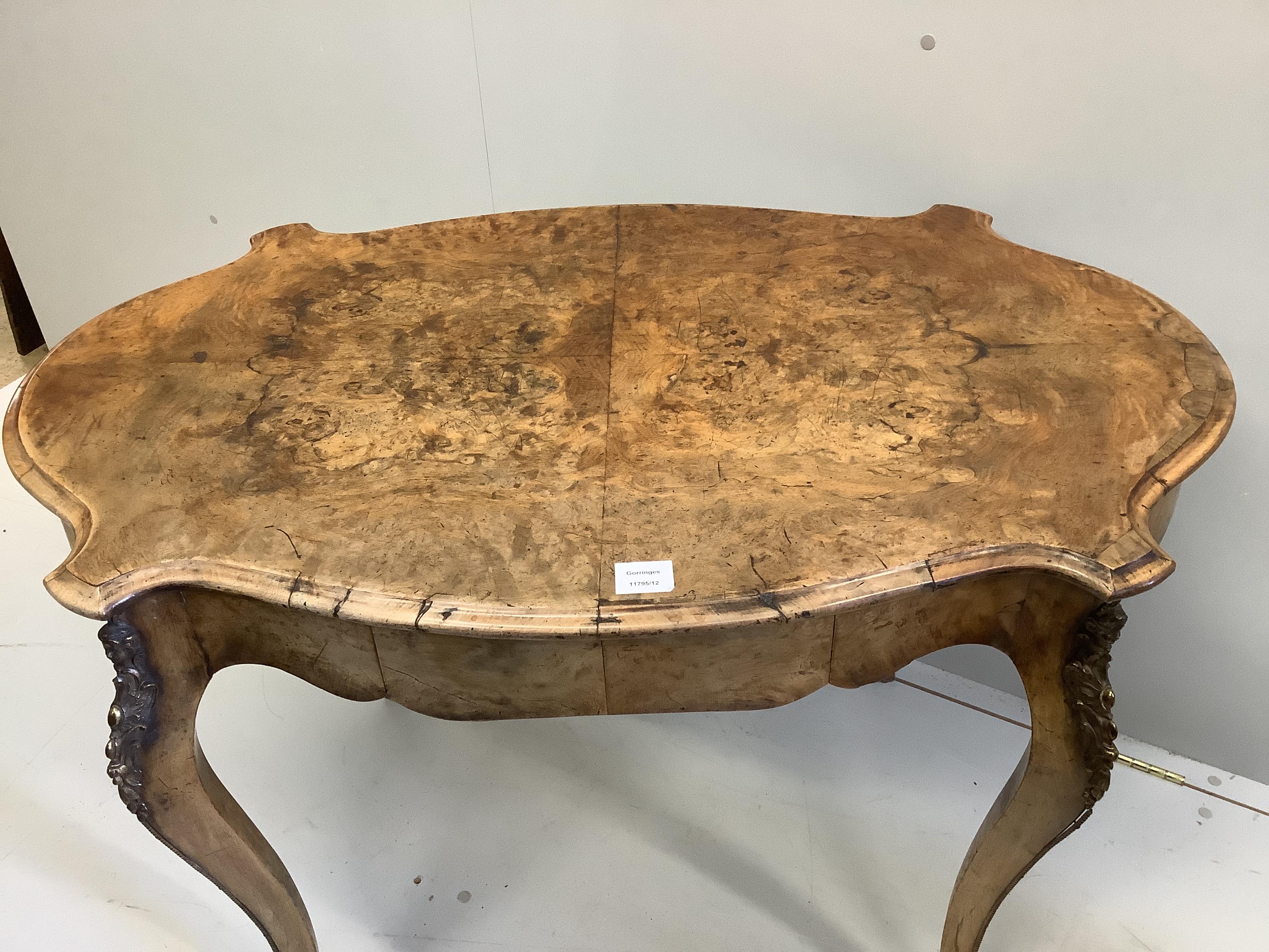 A Victorian gilt metal mounted oval walnut centre table, width 106cm, depth 66cm, height 74cm
